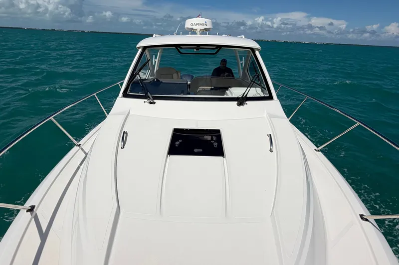 Slide: The Image of 2017 Pursuit OS 325 Offshore boat cruising on turquoise ocean waters under a clear sky. - 54