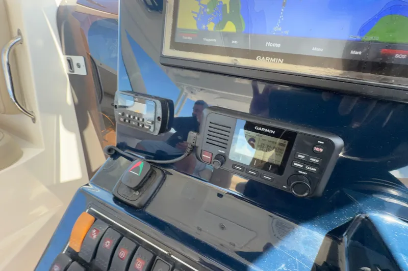 Slide: The Image of 2017 Pursuit OS 325 Offshore boat dashboard with Garmin navigation system. - 31