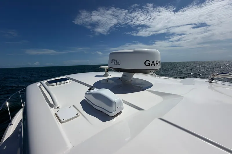 Slide: The Image of 2017 Pursuit OS 325 Offshore boat with Garmin radar on open sea under blue sky. - 13
