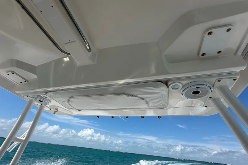 Slide: The Image of 2017 Pursuit OS 325 Offshore boat canopy with ocean view and clear blue sky. - 47