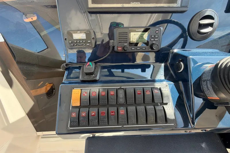 Slide: The Image of Control panel of a 2017 Pursuit OS 325 Offshore boat with Garmin electronics. - 27