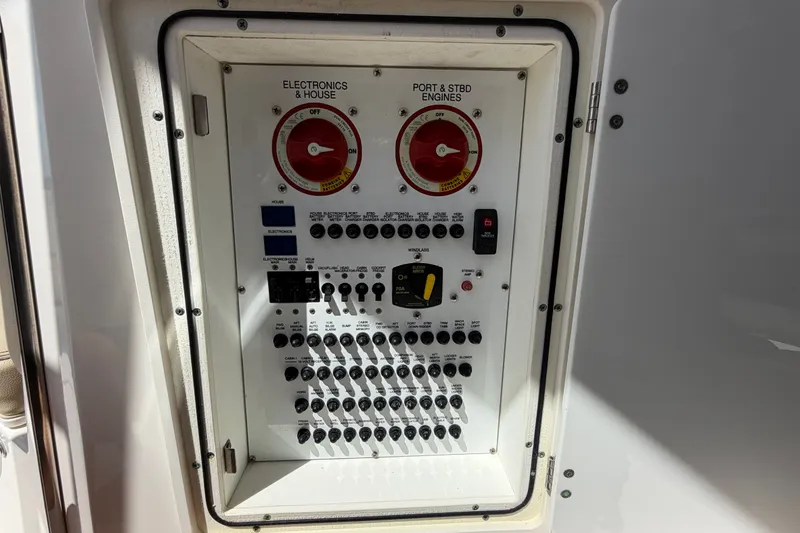 Slide: The Image of Electrical control panel on a 2017 Pursuit OS 325 Offshore boat. - 22