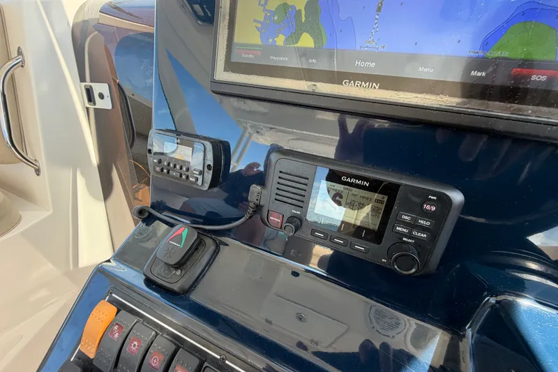 Slide: The Image of Control panel of a 2017 Pursuit OS 325 Offshore boat with Garmin navigation system. - 32