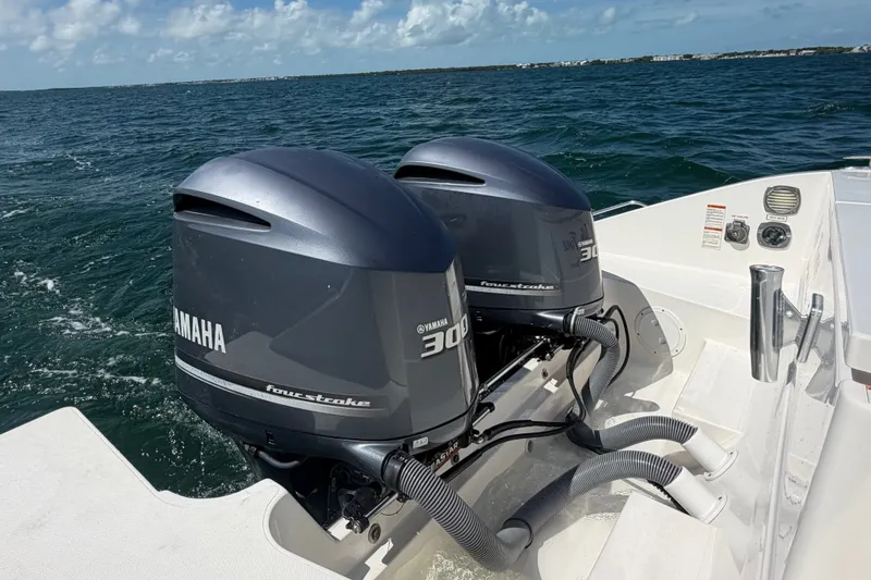Slide: The Image of 2017 Pursuit OS 325 Offshore boat with twin Yamaha 300 outboard engines on open water. - 15