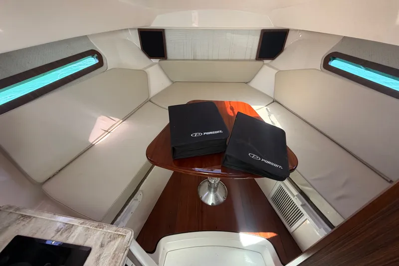 Slide: The Image of Interior cabin of 2017 Pursuit OS 325 Offshore boat with seating and table. - 36
