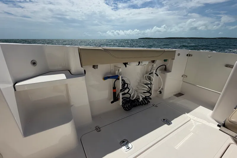 Slide: The Image of 2017 Pursuit OS 325 Offshore boat deck with ocean view and storage compartments. - 20