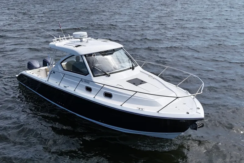 Slide: The Image of 2017 Pursuit OS 325 Offshore boat cruising on open water. - 5