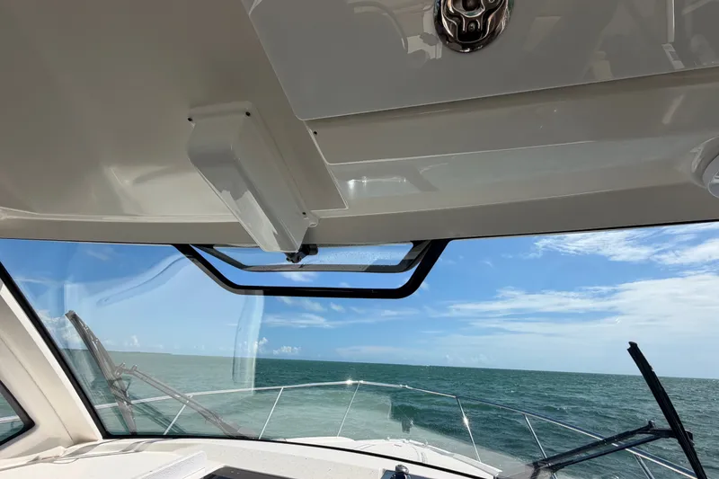 Slide: The Image of 2017 Pursuit OS 325 Offshore boat interior with ocean view through windshield. - 30
