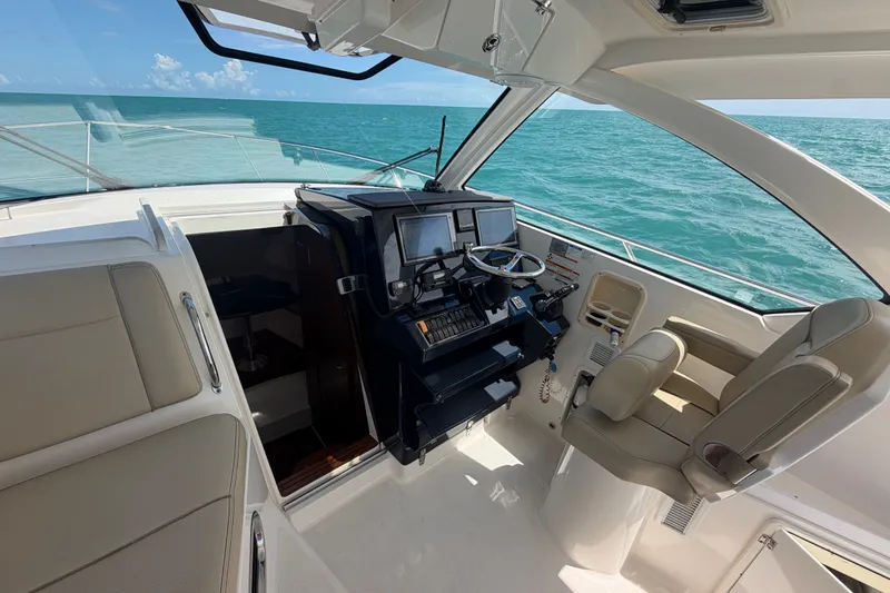 Slide: The Image of 2017 Pursuit OS 325 Offshore boat interior with helm, ocean view, and seating. - 48
