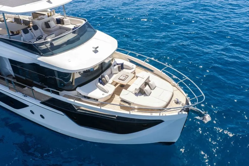 Slide: The Image of The 2028 Absolute Navetta 58 features a sleek design with a spacious deck and luxurious seating areas. - 5