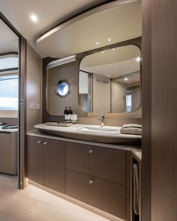 Slide: The Image of Luxurious bathroom with modern sink, mirror, and wooden cabinets on a yacht. - 15