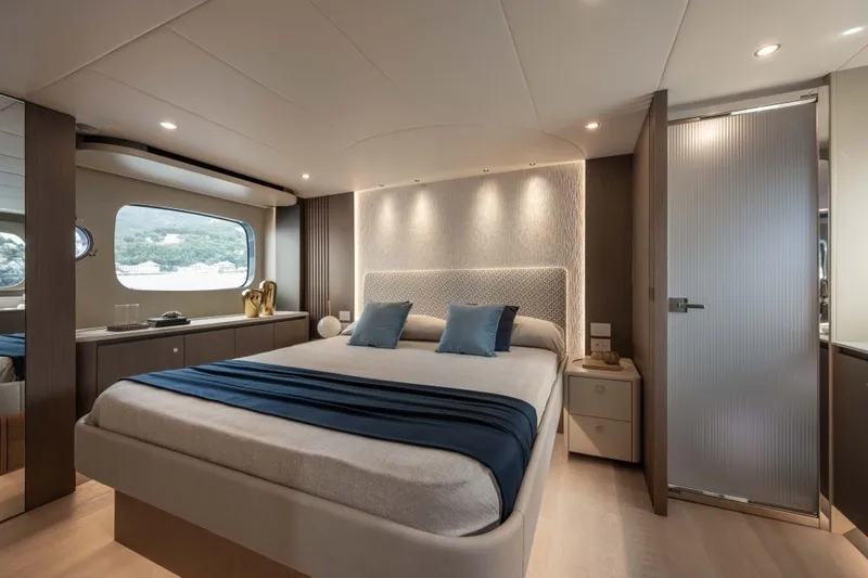Slide: The Image of Luxurious bedroom with a large bed, blue pillows, and stylish lighting on a yacht. - 16