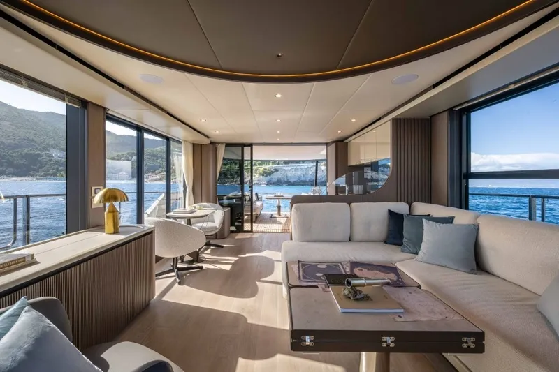 Slide: The Image of Luxurious salon of the Absolute Navetta 58 with panoramic windows and stylish decor, overlooking the sea. - 10