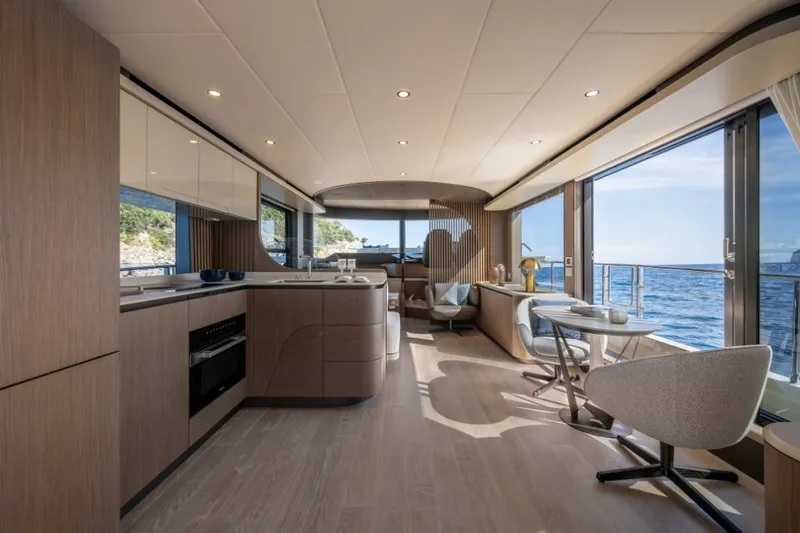 Slide: The Image of Interior of the 2028 Absolute Navetta 58 with modern design, large windows, and elegant furnishings. - 9