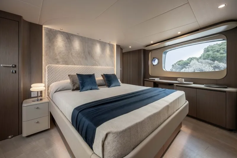 Slide: The Image of Luxurious bedroom with a large bed, elegant lighting, and a big window overlooking trees. - 13