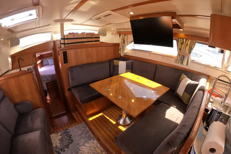 Slide: The Image of Luxurious interior of 2005 Catalina Morgan 440 yacht with cozy seating and elegant wood finishes. - 24