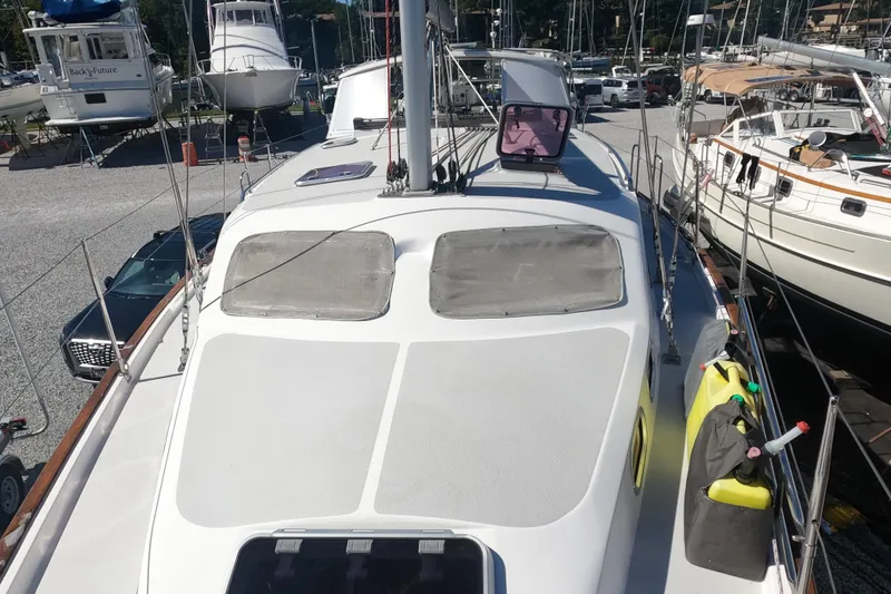 Slide: The Image of 2005 Catalina Morgan 440 sailboat on land, surrounded by other boats in a marina. - 16