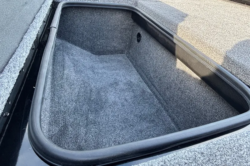 Slide: The Image of Storage compartment of 2027 Ranger RT188 boat, featuring carpeted interior and durable construction. - 13