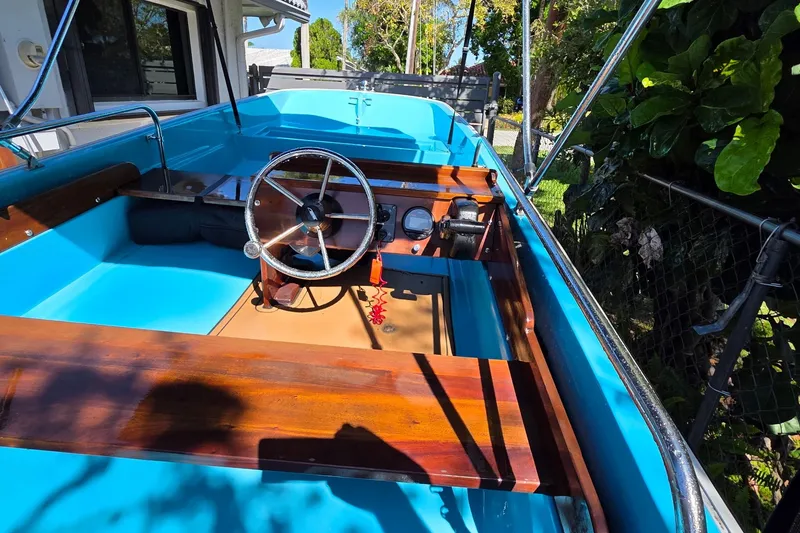 Slide: The Image of 1973 Boston Whaler 13 Sport boat interior with blue and wooden accents. - 17