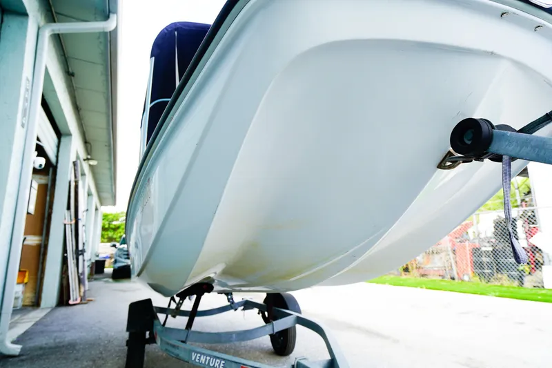 Slide: The Image of 1973 Boston Whaler 13 Sport boat on trailer, side view near garage. - 18