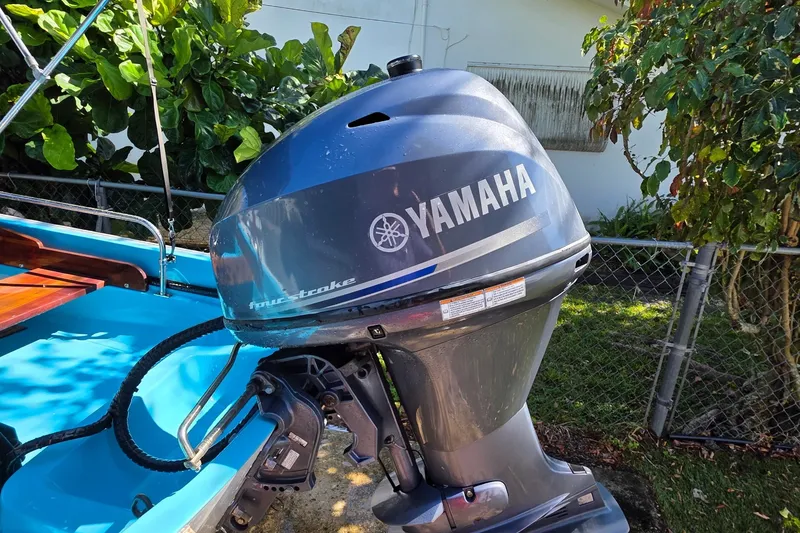 Slide: The Image of 1973 Boston Whaler 13 Sport with Yamaha four-stroke outboard motor, parked outdoors. - 18