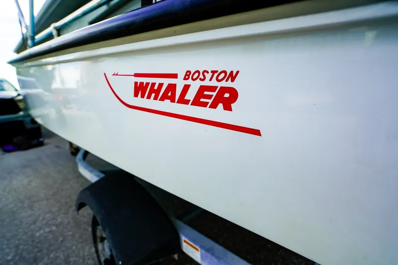 Slide: The Image of 1973 Boston Whaler 13 Sport boat on trailer, showcasing red logo. - 15