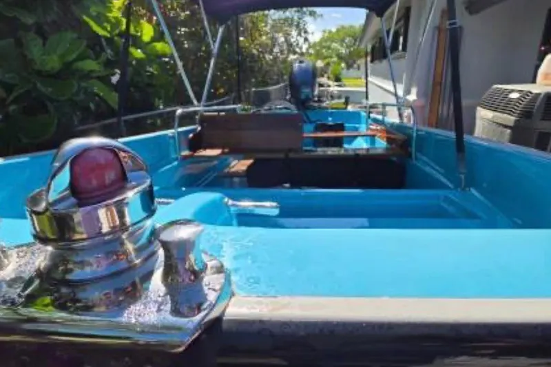 Slide: The Image of 1973 Boston Whaler 13 Sport boat interior with blue finish and chrome details. - 8