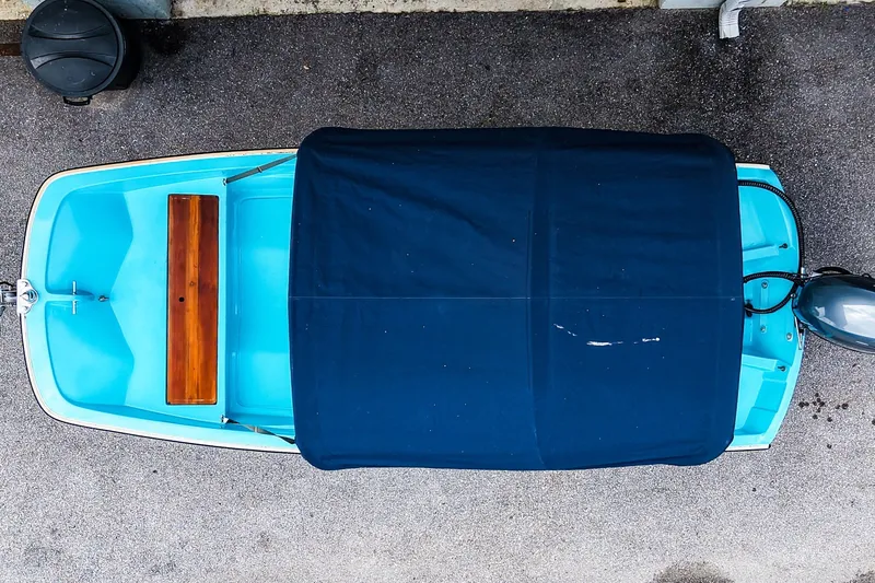 Slide: The Image of Overhead view of a 1973 Boston Whaler 13 Sport boat with blue cover. - 4