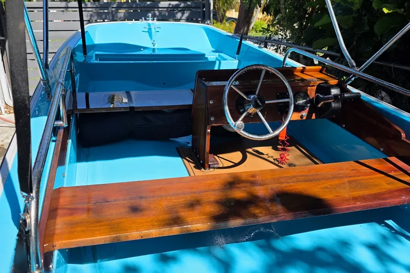 Slide: The Image of 1973 Boston Whaler 13 Sport boat interior with wooden accents and steering wheel. - 10