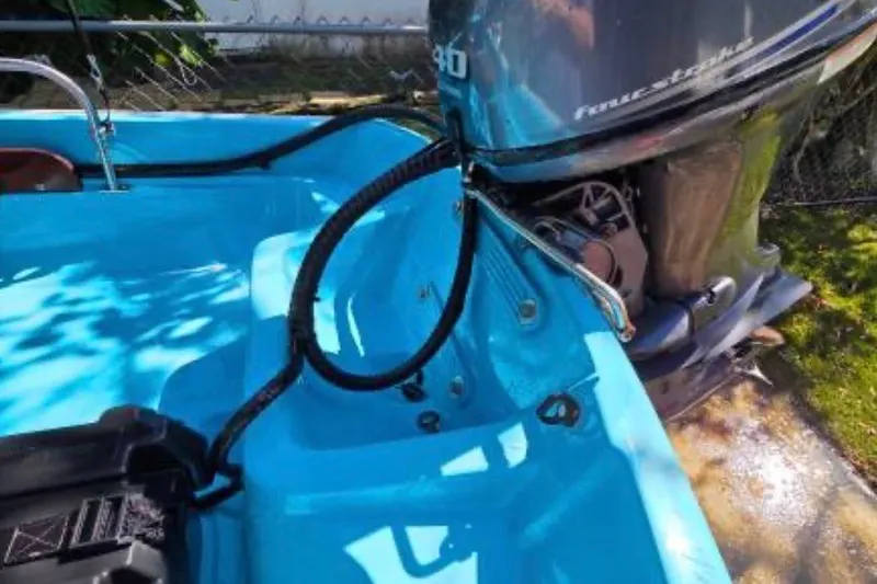 Slide: The Image of 1973 Boston Whaler 13 Sport boat with outboard motor, blue interior. - 4