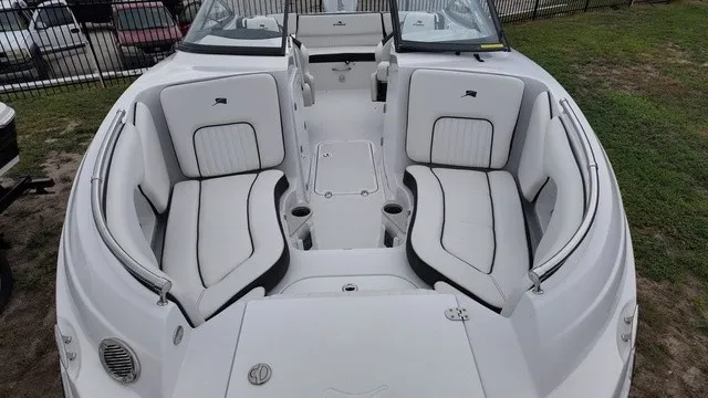 Slide: The Image of The image shows the cockpit of a 2027 Stingray 22DC boat with white cushioned seats. - 3