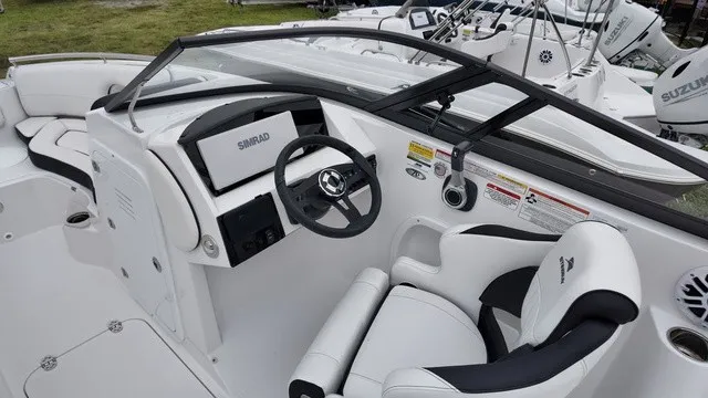 Slide: The Image of The image shows a modern boat cockpit with a Simrad display and comfortable seating. - 5