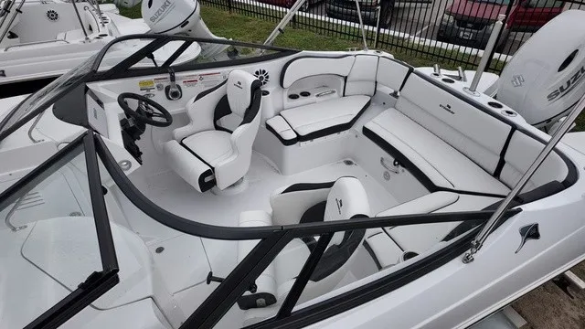 Slide: The Image of The image shows the cockpit of a 2027 Stingray 22DC boat with white and black seating. - 6
