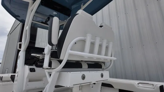 Slide: The Image of The image shows the cockpit of a Tidewater 2500 Carolina Bay boat with modern seating and rod holders. - 16