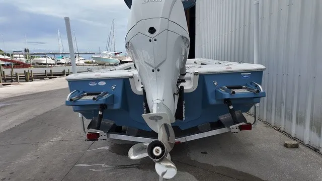 Slide: The Image of A 2027 Tidewater 2500 Carolina Bay boat is on a trailer next to a dock. - 20