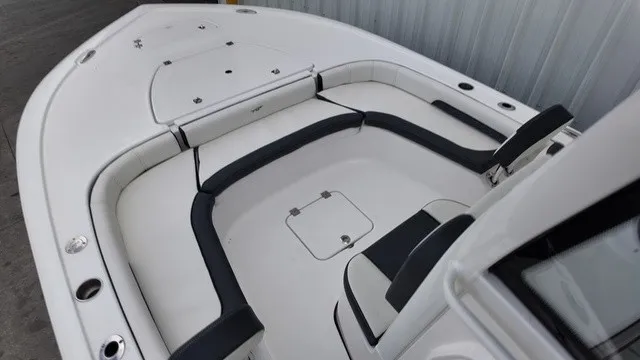 Slide: The Image of The image shows the cockpit of a 2027 Tidewater 2500 Carolina Bay boat with white and black upholstery. - 13