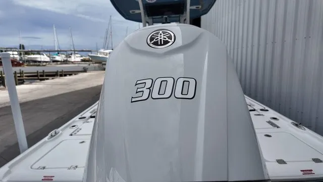Slide: The Image of A boat with a 300 HP engine, with yachts and a harbor visible in the background. - 19