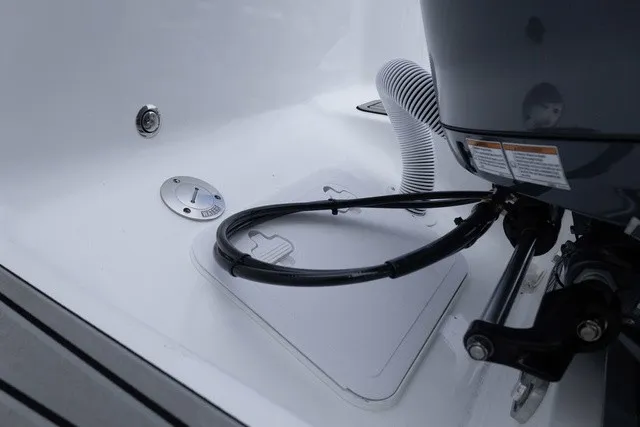 Slide: The Image of Close-up of the engine area on a Tidewater 232 CC Adventure boat with hoses and cables. - 17