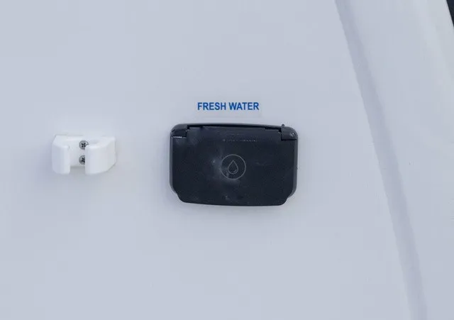 Slide: The Image of Fresh water connection on a boat, featuring a small black cover and blue labeling. - 3