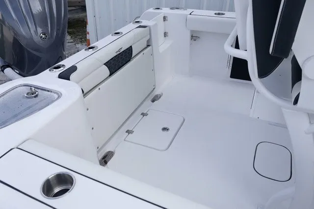 Slide: The Image of The image shows the cockpit of a Tidewater 232 CC Adventure boat with white seating and stainless steel details. - 15