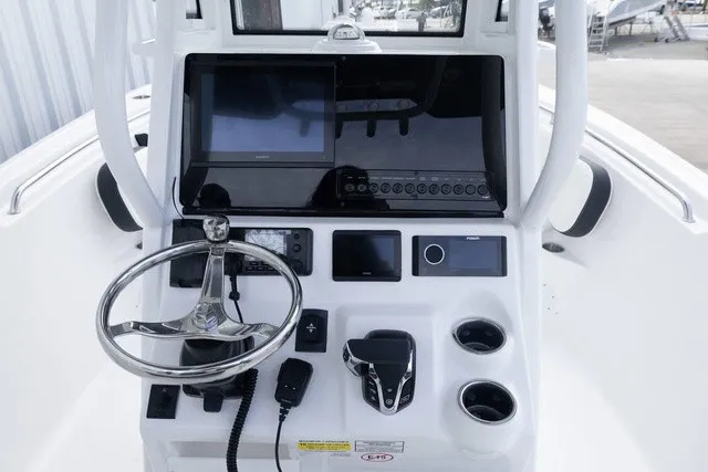Slide: The Image of The image shows the helm of a Tidewater 232 CC Adventure boat with modern instruments. - 12