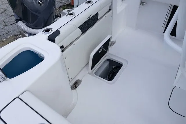 Slide: The Image of The image shows the cockpit of a Tidewater 232 CC Adventure boat with storage and engine. - 14