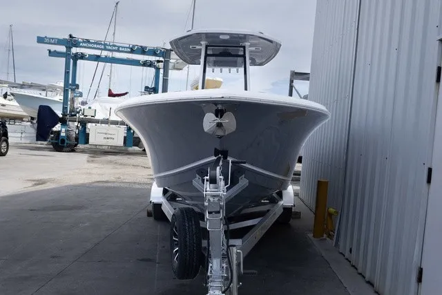 Slide: The Image of A 2027 Tidewater 232 CC Adventure boat on a trailer beside a building. - 25