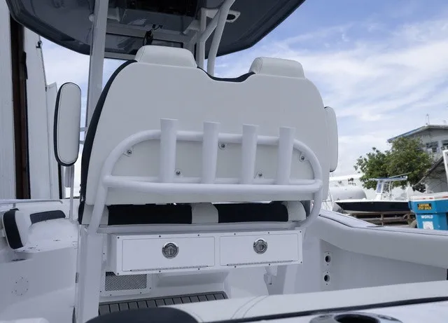 Slide: The Image of The image shows the cockpit of a Tidewater 232 CC Adventure boat with rod holders and storage. - 18