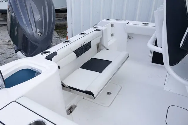 Slide: The Image of The image shows the cockpit of a Tidewater 232 CC Adventure boat with white and black seating. - 13