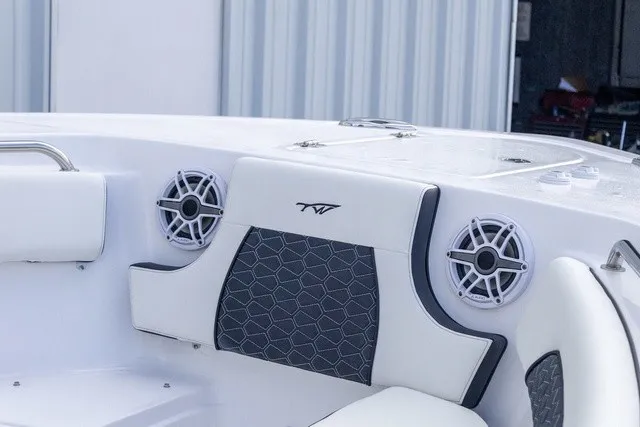 Slide: The Image of The image shows the cockpit of a Tidewater 232 CC Adventure boat with speakers and cushioned seating. - 6