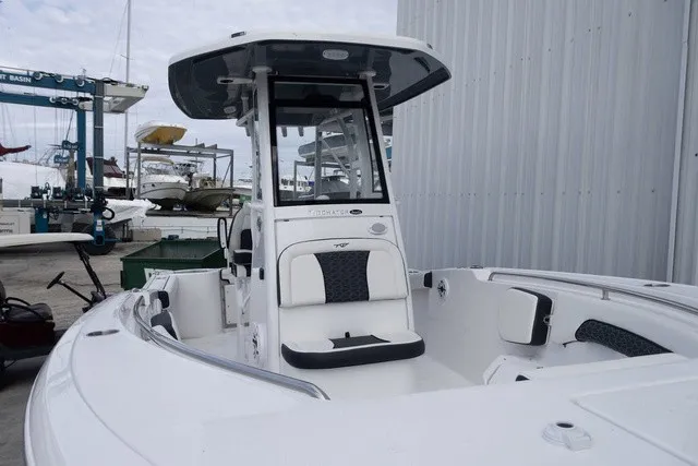 Slide: The Image of The image shows a modern boat with a central console and cushioned seating. - 2