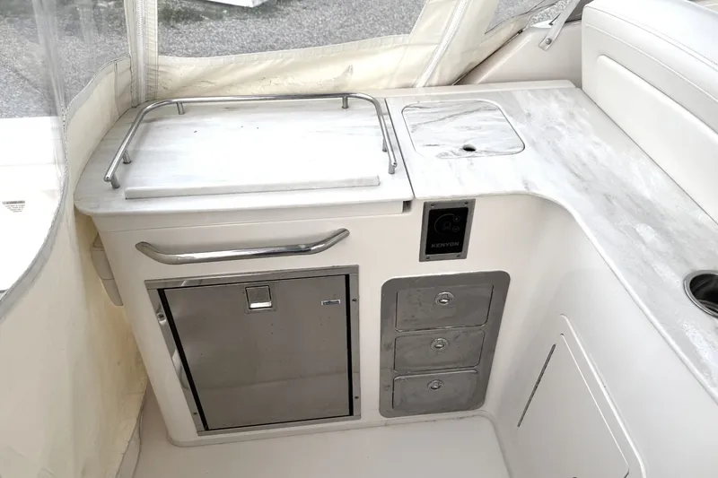Slide: The Image of 2020 Grady-White Freedom 325 boat interior with kitchenette and storage drawers. - 14