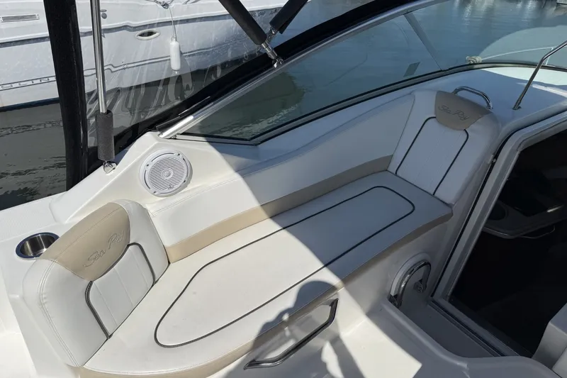 Slide: The Image of Interior view of a 2009 Sea Ray 230 Sundancer boat with white seating and speaker. - 6