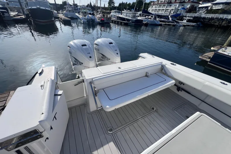Slide: The Image of 2020 Southport 33 FE boat with dual engines docked at a marina. - 27